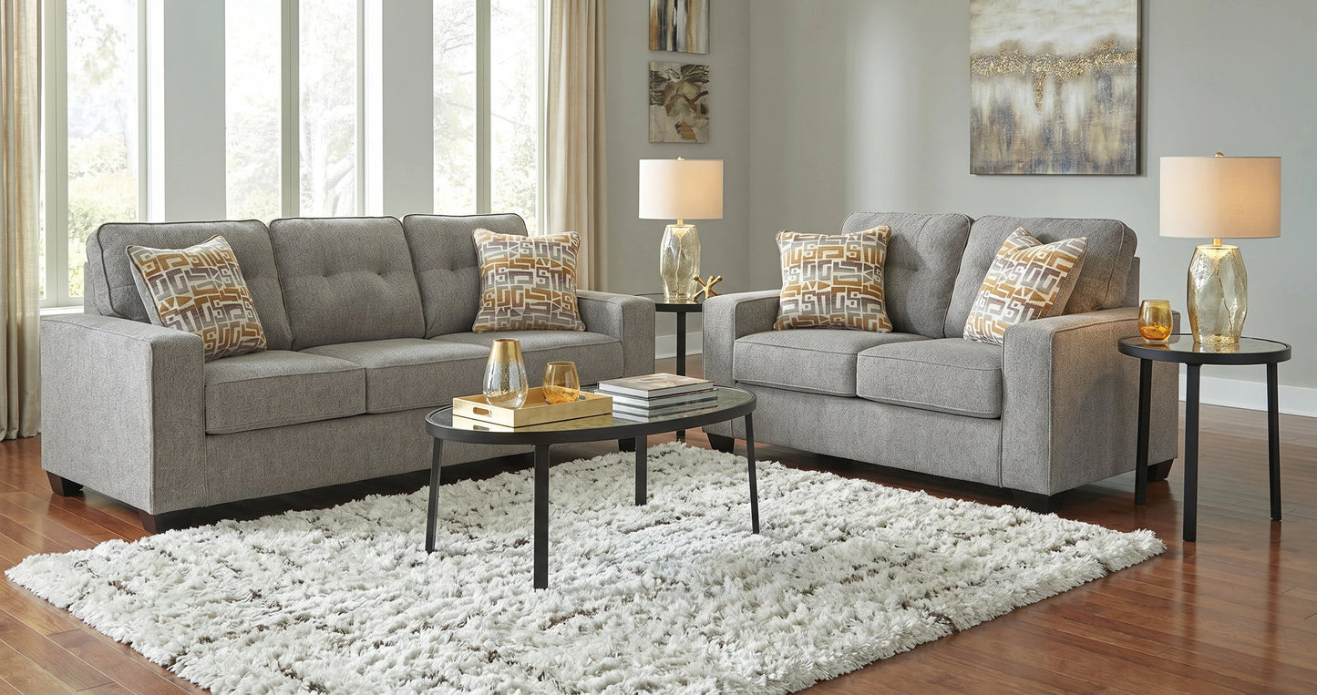 Gray sofa set with decorative pillows in a living room setting.