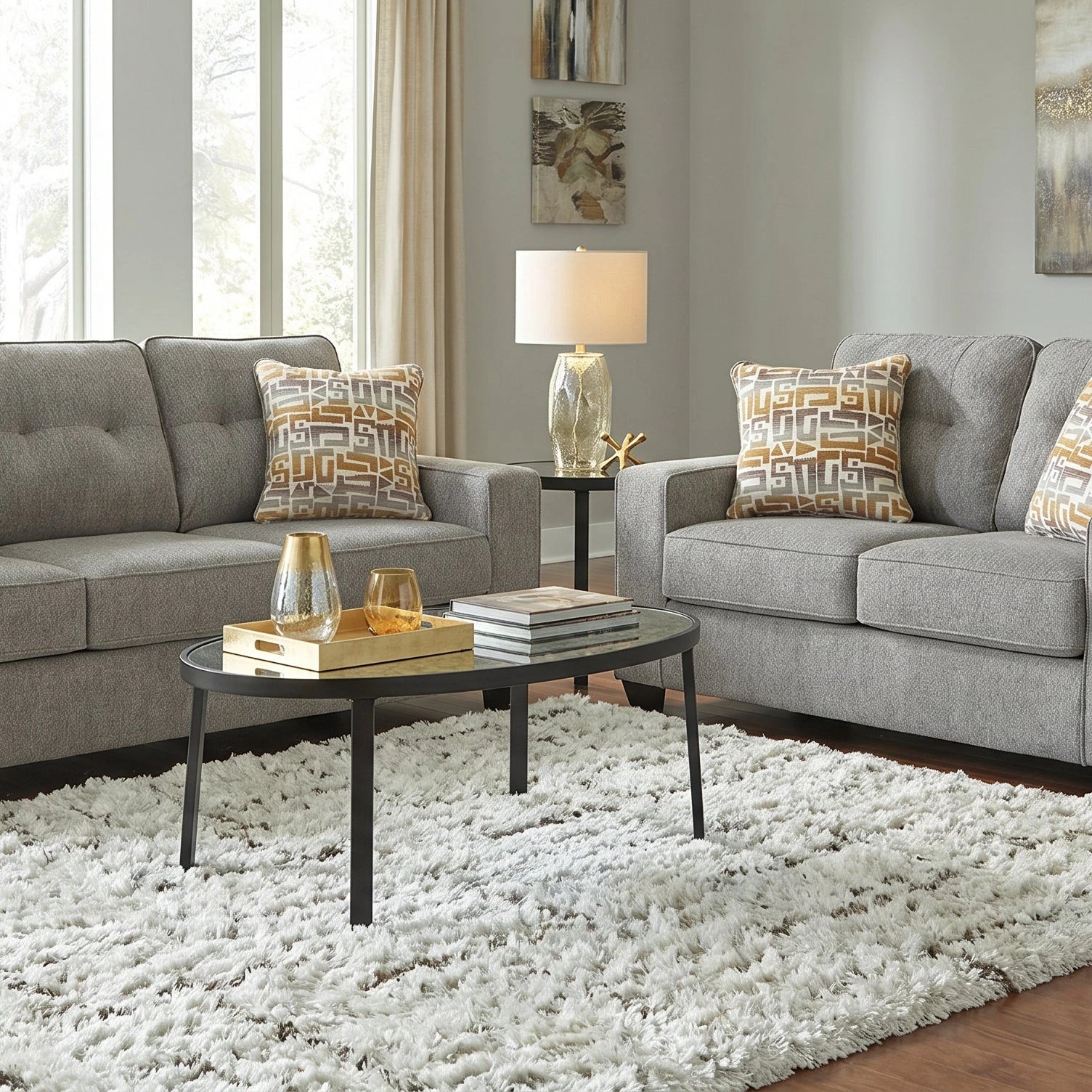 Gray sofa set with decorative pillows in a living room setting.